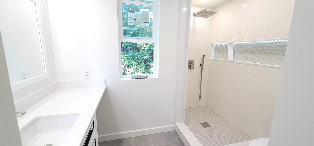 Picture of a small bathroom with a white bathtub and and white sink