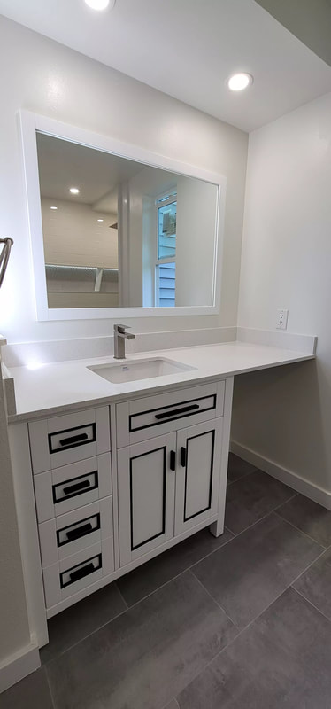 A picture of a light-tan free standing vanity with sinks and basins.