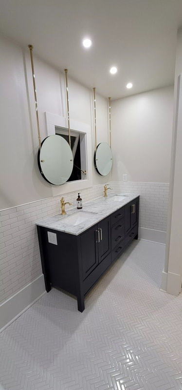 A picture of a light-tan free standing vanity with sinks and basins.